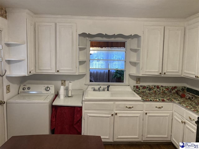 laundry room featuring washer / clothes dryer, sink, and cabinets