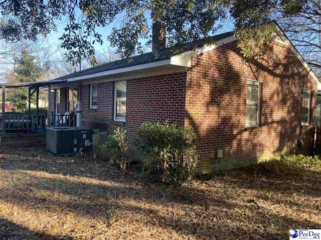 view of side of home featuring central AC