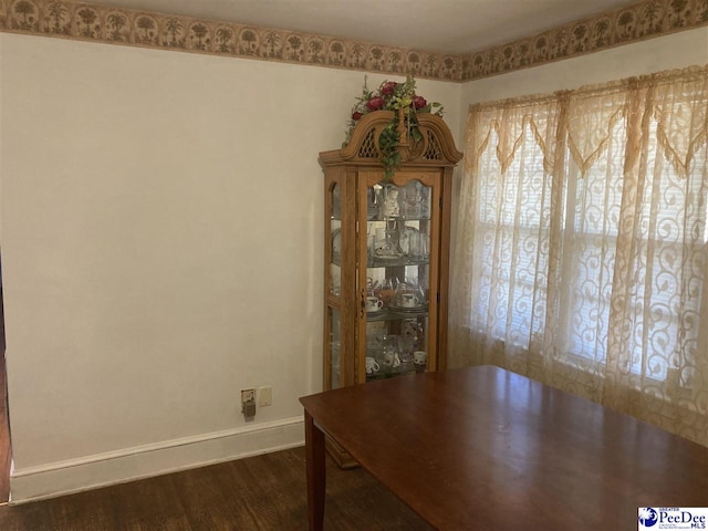 unfurnished dining area with dark hardwood / wood-style floors