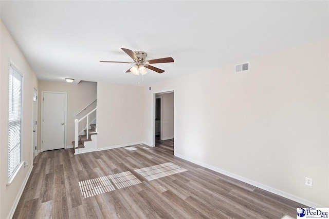 empty room featuring hardwood / wood-style flooring and ceiling fan