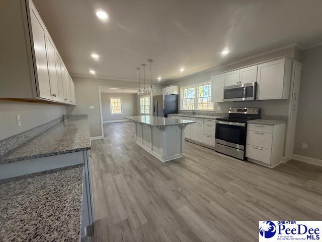 kitchen with light stone counters, stainless steel appliances, recessed lighting, light wood-style floors, and white cabinets