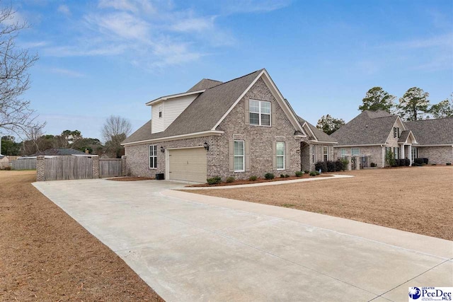 view of property featuring a garage and a front yard