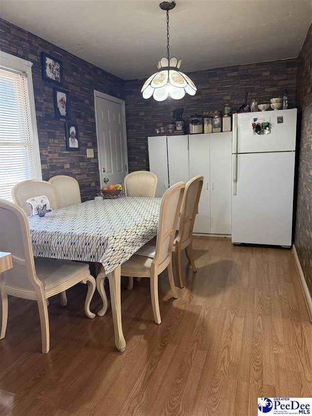 dining area with light hardwood / wood-style floors