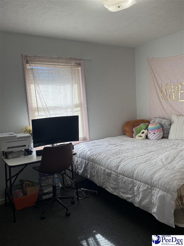 carpeted bedroom featuring a textured ceiling