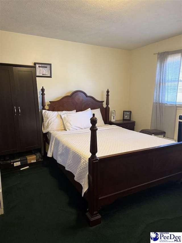 carpeted bedroom featuring a textured ceiling