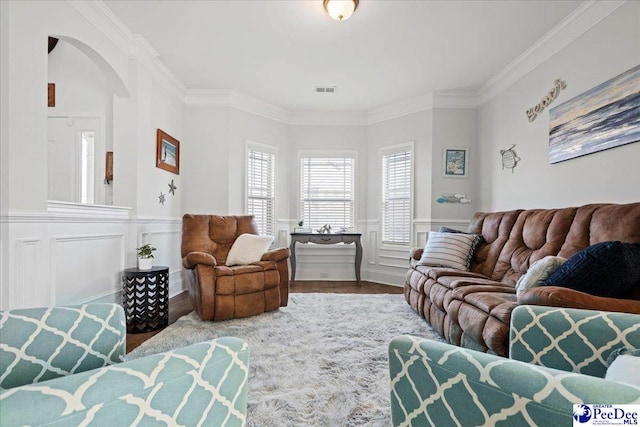 living room with wood-type flooring and ornamental molding