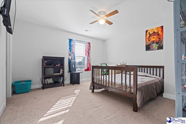 bedroom featuring ceiling fan and carpet