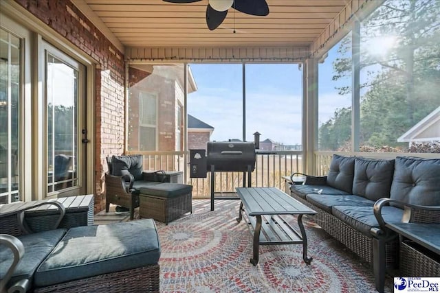 sunroom / solarium featuring ceiling fan and wooden ceiling