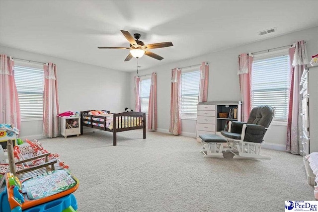 bedroom with ceiling fan and light colored carpet