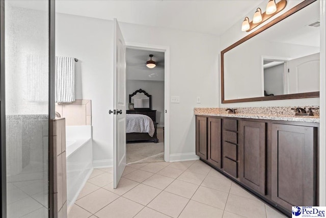 bathroom with vanity, a tub to relax in, and tile patterned flooring