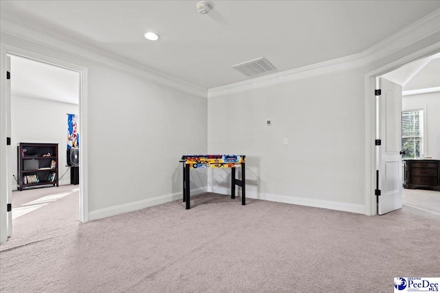 recreation room with ornamental molding and light colored carpet