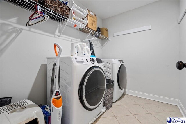 washroom featuring washer and dryer and light tile patterned floors