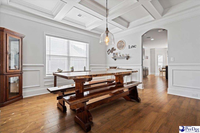 dining area featuring hardwood / wood-style floors, crown molding, and beamed ceiling