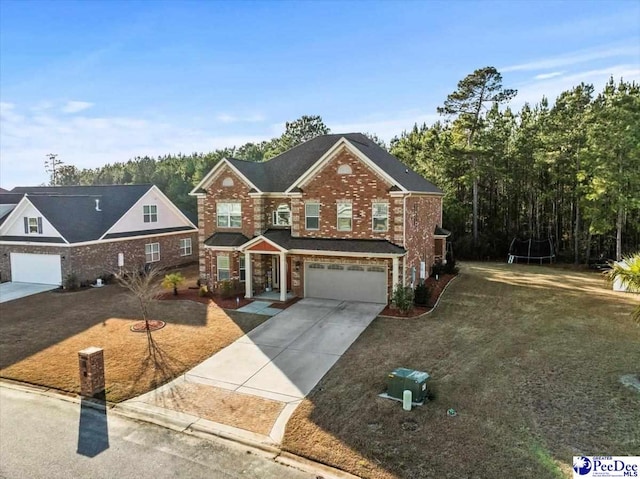 view of front of house with a garage and a front lawn