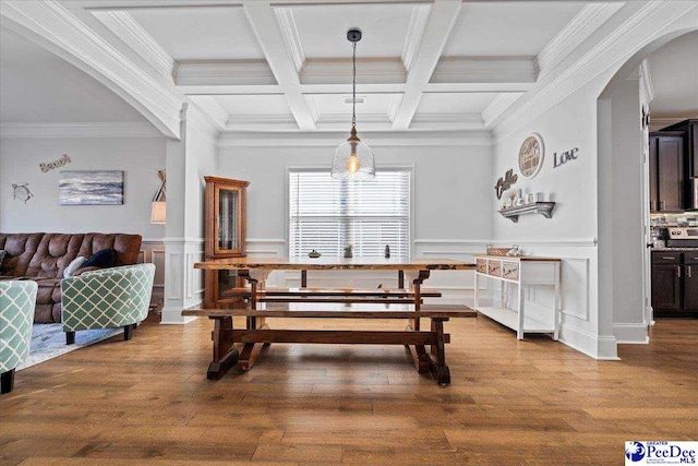 dining area featuring coffered ceiling, hardwood / wood-style floors, crown molding, and beamed ceiling