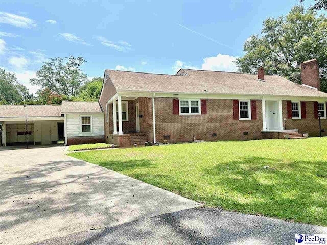 ranch-style home with a carport and a front yard