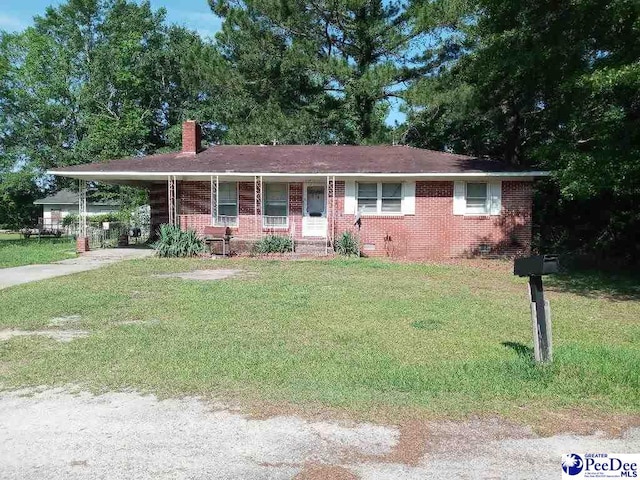 single story home with a front lawn, a carport, and a porch