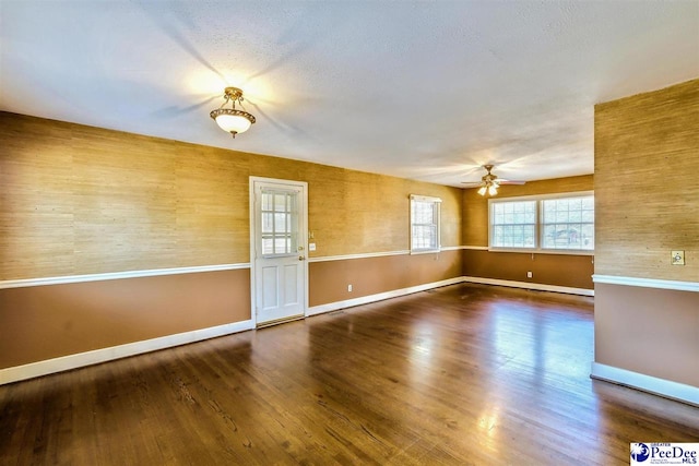 spare room featuring dark hardwood / wood-style flooring and ceiling fan