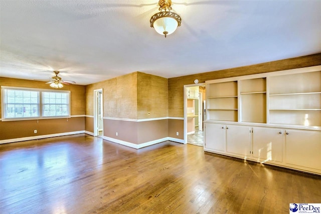 unfurnished room featuring ceiling fan and wood-type flooring