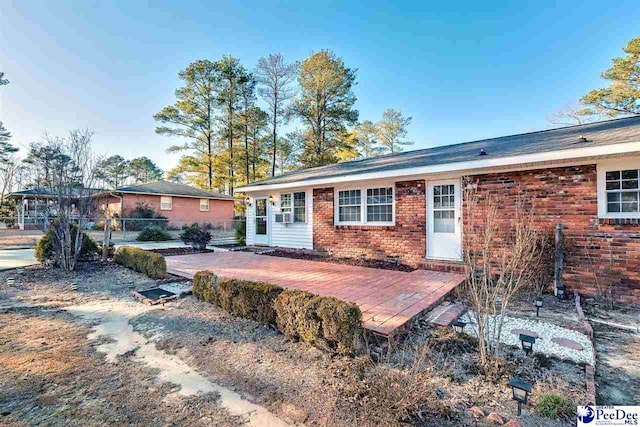 rear view of property featuring a deck