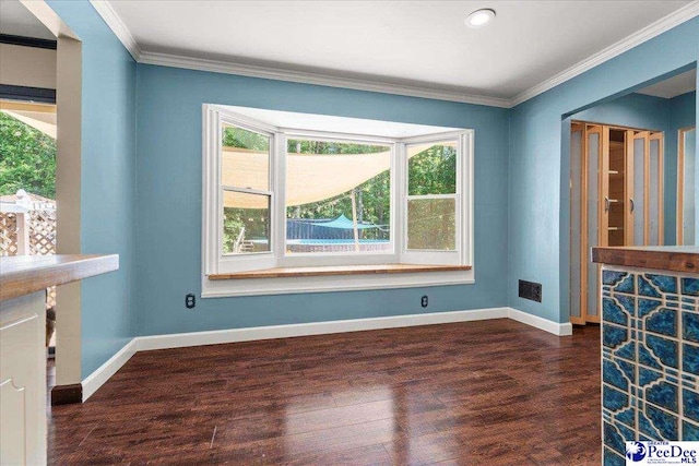 unfurnished living room with baseboards, recessed lighting, crown molding, and wood finished floors