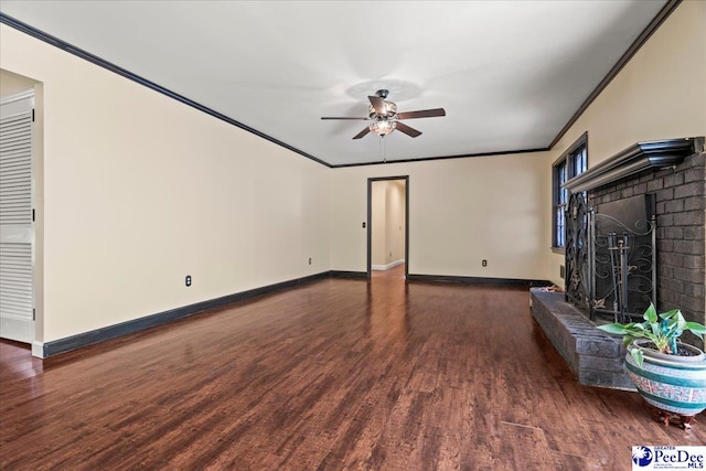 unfurnished living room with baseboards, ornamental molding, ceiling fan, wood finished floors, and a fireplace
