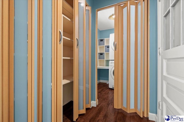 interior space featuring baseboards, stacked washer and dryer, and dark wood finished floors