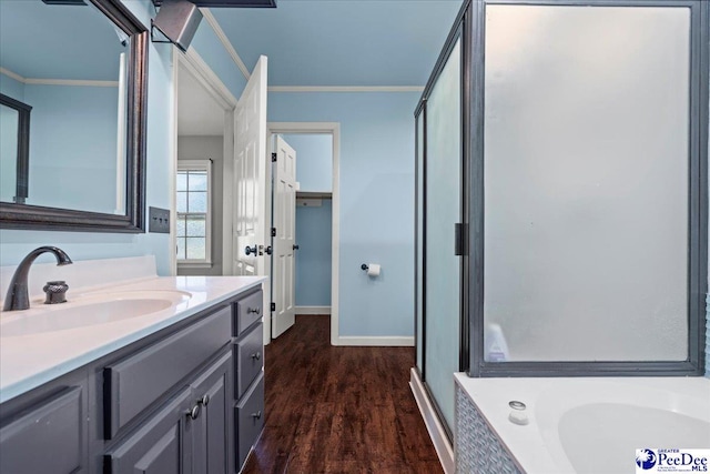 full bath with a stall shower, ornamental molding, a bath, vanity, and wood finished floors