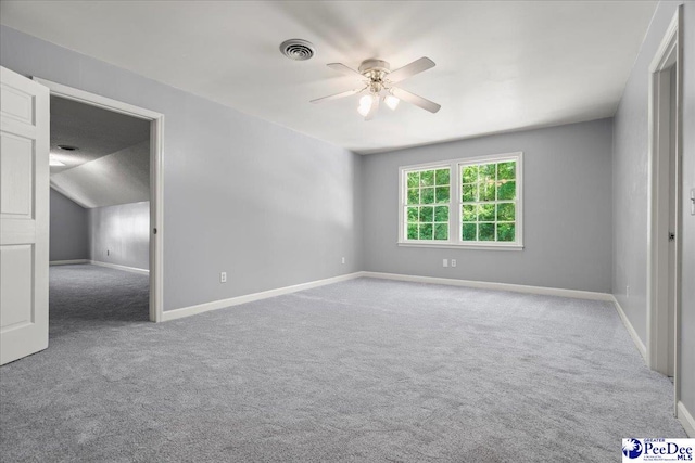 unfurnished bedroom with lofted ceiling, carpet, baseboards, ceiling fan, and visible vents