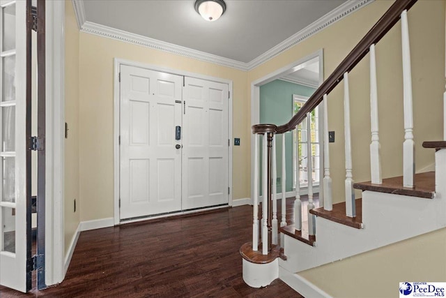 foyer entrance featuring stairway, ornamental molding, baseboards, and dark wood finished floors