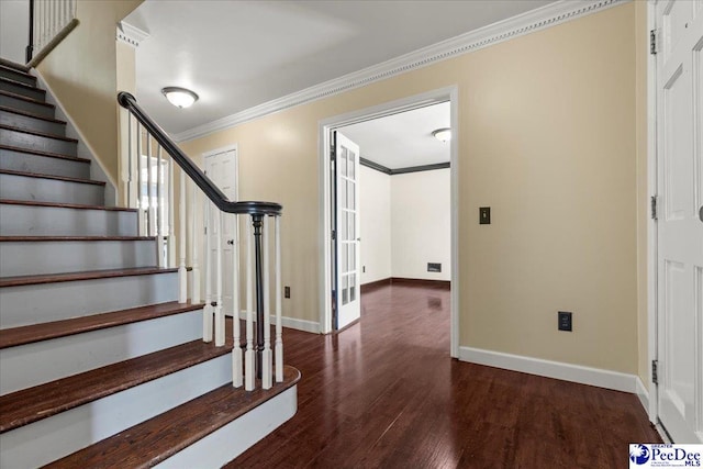 staircase with wood finished floors, baseboards, and ornamental molding
