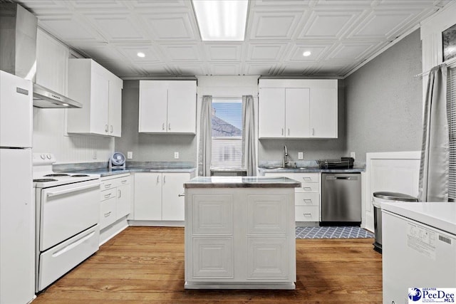 kitchen featuring sink, white cabinets, white appliances, light wood-type flooring, and wall chimney exhaust hood