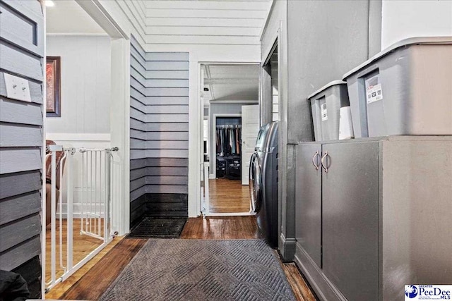 hall featuring dark wood-type flooring and wood walls