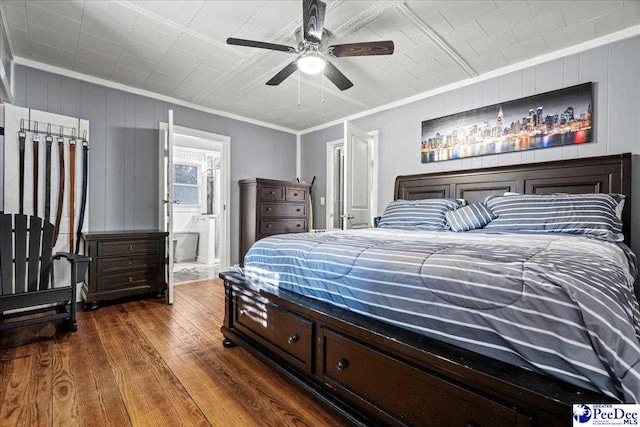 bedroom featuring ornamental molding, dark hardwood / wood-style floors, ceiling fan, and ensuite bathroom