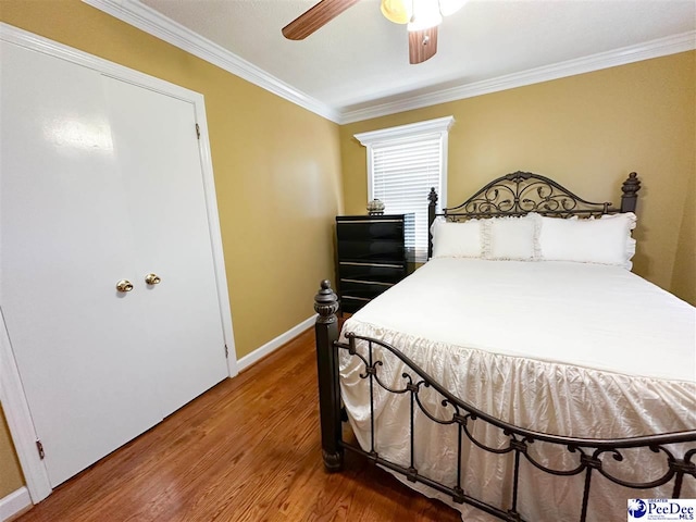 bedroom with ceiling fan, ornamental molding, and wood-type flooring