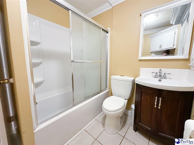 full bathroom featuring shower / bath combination with glass door, tile patterned flooring, ornamental molding, vanity, and toilet