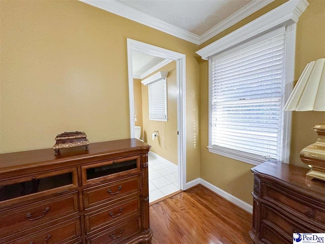 interior space featuring crown molding and light wood-type flooring