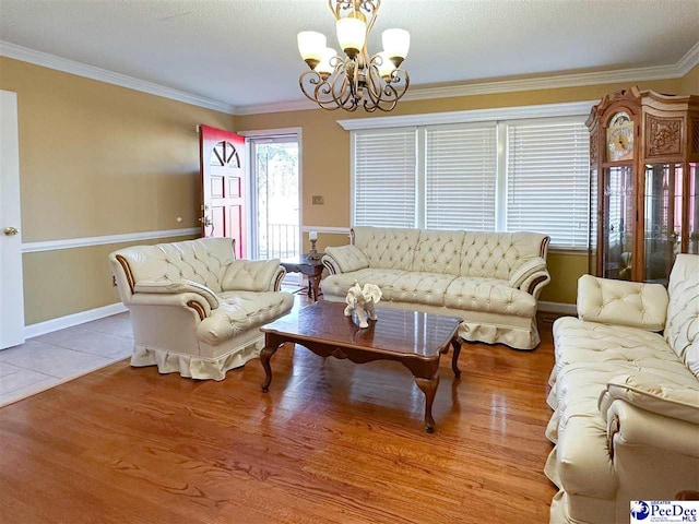 tiled living room featuring a notable chandelier and ornamental molding