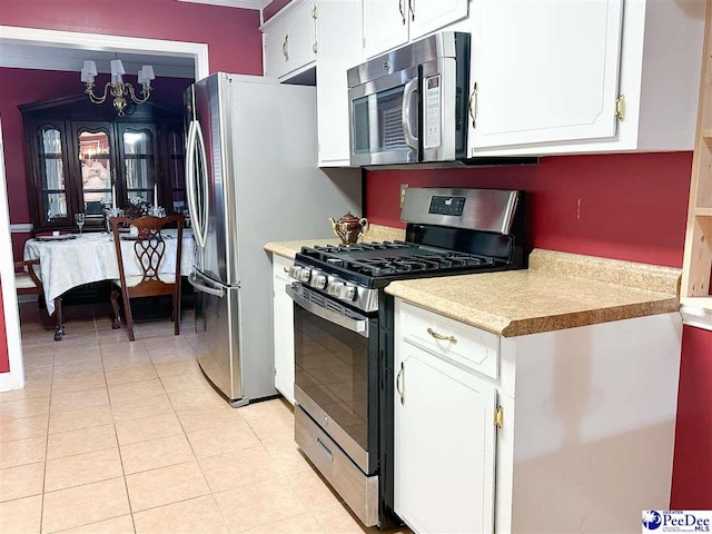 kitchen with white cabinetry, appliances with stainless steel finishes, and light tile patterned flooring