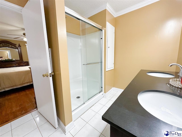 bathroom with ornamental molding, tile patterned floors, an enclosed shower, and a textured ceiling