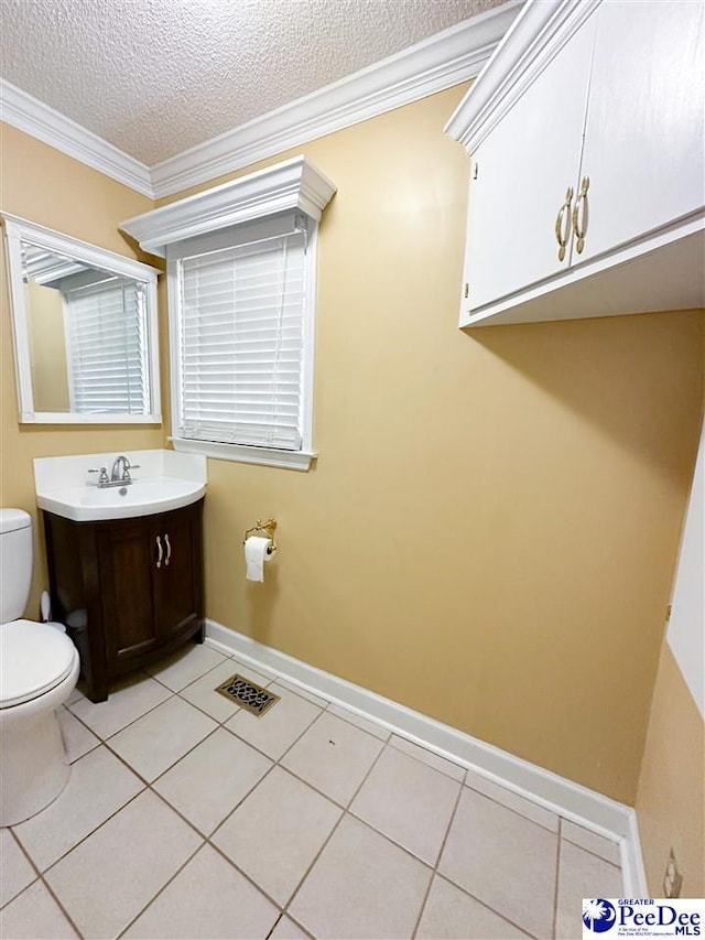 bathroom featuring toilet, crown molding, a textured ceiling, vanity, and tile patterned flooring