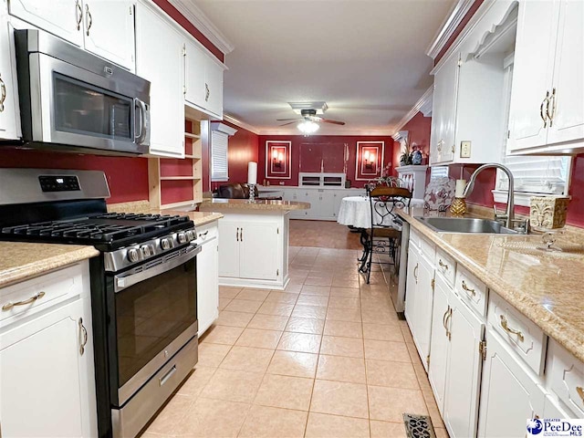 kitchen featuring crown molding, white cabinetry, appliances with stainless steel finishes, and sink