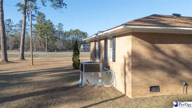 view of side of property with central AC