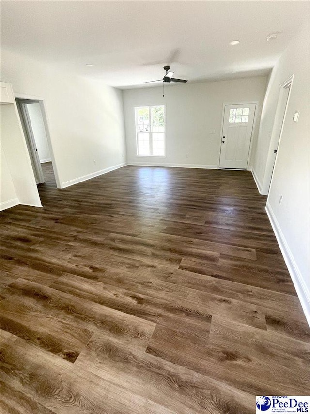 51 Boyd Ln, Cheraw, SC 25920 - unfurnished living room with a ceiling fan, dark wood-style floors, healthy amount of natural light, and baseboards