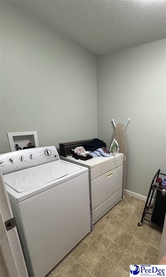 1124 N 4th Ave, Dillon, SC 29536 - washroom with separate washer and dryer and a textured ceiling
