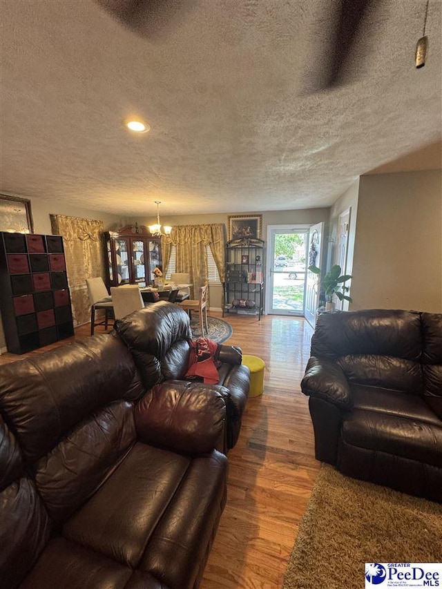1124 N 4th Ave, Dillon, SC 29536 - living room featuring a textured ceiling, a chandelier, wood finished floors, and recessed lighting