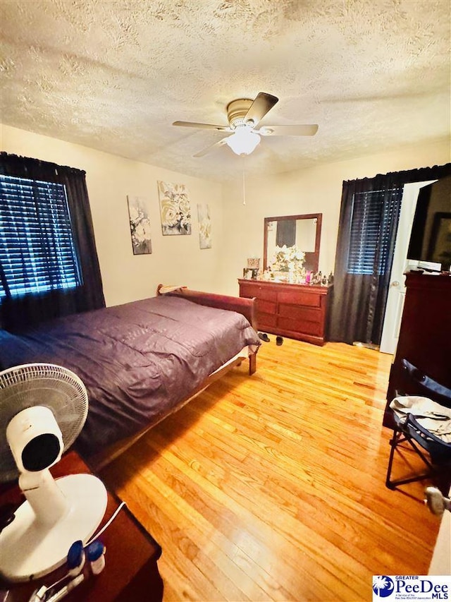 1124 N 4th Ave, Dillon, SC 29536 - bedroom with wood finished floors, a textured ceiling, and ceiling fan