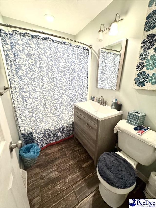 1124 N 4th Ave, Dillon, SC 29536 - full bath featuring wood finished floors, vanity, and a shower with shower curtain