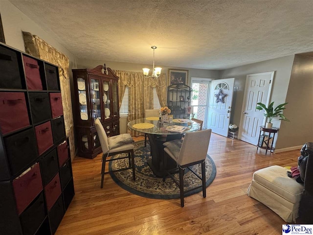 1124 N 4th Ave, Dillon, SC 29536 - dining space featuring a textured ceiling, a chandelier, and light wood finished floors