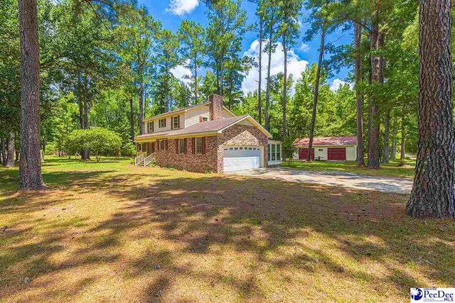 view of front of property featuring a garage and a front yard